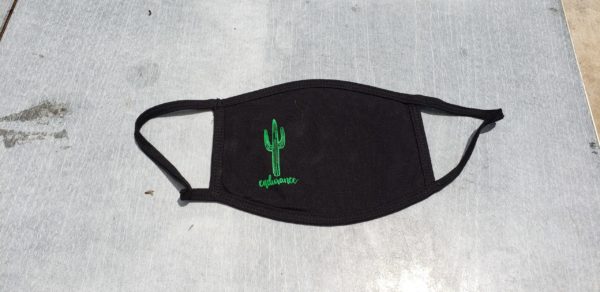 handmade fair trade black face mask with a green, screen printed design on the left-hand side of the mask of a two-limbed sugaro with the word, "endurance" below it in cursive.