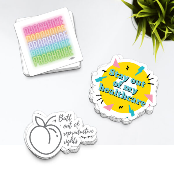 three pack stickers with prochoice rainbow, a donut circle that is yellow with blue text saying "stay out of my healthcare", and a white and grey sticker with a peach and cursive text "butt out of my reproductive rights"