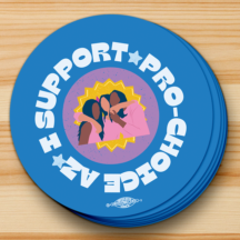 round blue sticker with white text aligned with the circle "I support pro-choice az". There is a group of three people in the center hugging each other. A union bug sits at the bottom of the sticker.